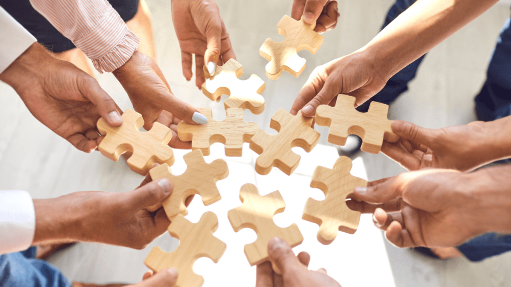 Gruppo di colleghi che gioca con un puzzle durante una sessione di gamification
