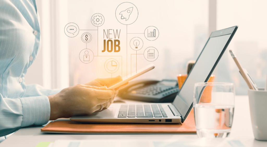 Professionista con tablet e laptop mentre valuta nuove opportunità di carriera, simbolo del job hopping nel mondo digitale.